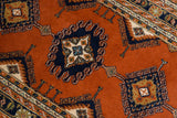 Vintage Indian Turkmen runner's contour medallion with navy, rust, ivory, and hook motifs.