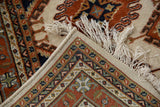 Hand knotted Indian Turkmen rug with securely finished selvage and intact ivory fringe.