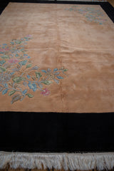 Ornate Art Deco floral spray in blush, green, silver on pale apricot field with black border.