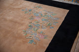 Ornate pastel floral spray on pale apricot field contrasting a jet black border, Art Deco rug.