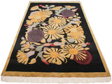 Vintage Indian Art Deco rug: gold starburst flowers, mauve, raspberry, and copper green on black.