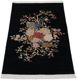 Upper corner of the Indian Art Deco rug showing plain navy black pile and white fringe.
