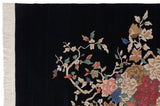 Corner view of vintage Indian Art Deco carpet with ivory fringe, roses, and vinery.