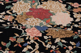 Art Deco Indian carpet with dense rose and vinery in rose, ivory, blush on navy black.