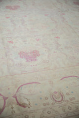 The soft, even pile of a vintage Kerman design rug with raspberry floral bouquets on an ivory field.