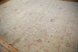 A view across the distressed ivory field showing staggered floral bouquets in raspberry red.