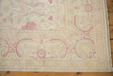 Original side cord selvage and raspberry floral border on a vintage distressed Bulgarian carpet.