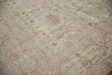 Faded cochineal red florals on the soft, distressed pile of a vintage Bulgarian carpet.