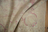 Soft folds revealing the plush, even wool pile of a vintage Bulgarian carpet.