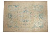 Vintage distressed Polonaise design carpet with a floral medallion in soft sky blue, blush, and cream.