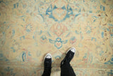Low pile and even wear on a distressed vintage rug with soft blue and blush floral details.