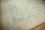 Worn texture and floral border in sky blue and blush on a vintage Polonaise carpet.