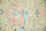 Detailed view of the distressed carpet's low pile and visible hand-knotted texture.