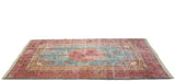 Angled view of a fine vintage Kerman carpet highlighting the lustrous sheen on its floral pile.