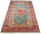Full view of a vintage Persian Kerman carpet showing its ornate Rococo floral design.
