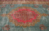 Ornate scalloped medallion with millefleur design on a dusty powder blue Kerman carpet field.