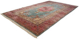 Full-length angled view of an oversize Kerman carpet with Rococo and millefleur floral designs.