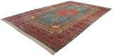 Angled view across a fine vintage Kerman carpet, showing its lustrous pile and intricate floral design.