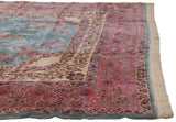 Corner view of a fine Kerman carpet showing its Rococo floral borders and dense, plush pile.
