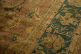 Herati motif detail of vintage Agra carpet in copper, gold, and dusty teal.