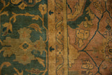 Hand-knotted Herati motif detail on vintage Agra carpet, with dusty teal and copper tones.