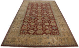 Angled perspective of a large Agra carpet with a repeating oversized palmette design on a cherry red field.