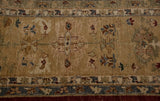 Nuanced color fills in the palmette motifs and border of a hand-knotted Agra carpet.