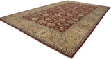 A long view of the Agra carpet's allover palmette design and wide, sand-colored border.