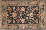 Agra carpet with allover floral palmettes and cloudbands on a charcoal field and slate blue border.