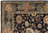 Detailed corner of a hand-knotted Agra carpet with a slate blue and terra cotta arabesque border.
