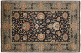 Close-up of the Agra carpet's slate blue border with its classic dragon and arabesque motif.