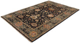 Full length angled view of a hand-knotted Agra carpet showing its charcoal field and floral motifs.