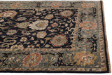 Corner view of an Agra carpet's hand-knotted pile and slate blue dragon and arabesque border.