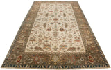 Indian Serapi design carpet viewed from an angle, showing its full length and sprawling vine motifs.