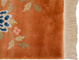 Peking rug copper field, blue blossom, full fringe, and intact side cord.