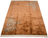 Copper Art Deco rug with deeply carved borders and pastel floral clusters.