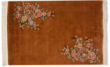 Art Deco rug corner: sprawling floral motifs, shadow embossed carving, copper, blush, mauve tones, fringe.