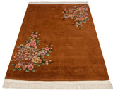 Vintage Art Deco rug showcasing copper field, shadow carved border, and sprawling floral motifs.