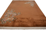 Detailed corner of Art Deco carpet with sprawling blush floral vines and dimensional carved border.