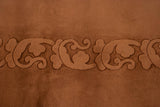 Ornate dimensional carving of sprawling foliage on a vintage Art Deco carpet, blush tone.