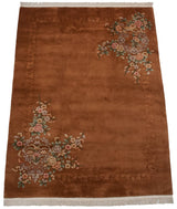 Vintage copper Art Deco rug corner with sprawling pastel florals and embossed border.