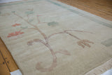 Hand-knotted Chinese Arts and Crafts rug's stylized tree, ocean green and terra cotta blossoms, light border.
