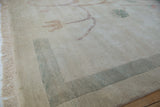 Fringed corner of a Chinese Arts and Crafts vintage rug with muted green banded border.