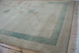 Ocean green abrashed border and natural fringe on a vintage Chinese carpet.