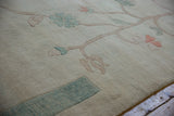 Ivory vintage Chinese Arts and Crafts rug with terra cotta blossoms and ocean green border.