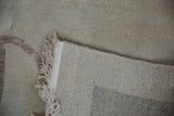 Tightly woven foundation texture and natural ivory fringe on a hand-knotted Chinese carpet.