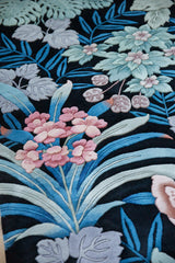 Modern jungle carpet detail with carved pink blossoms and blue foliage.
