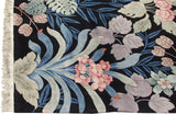 Fringe and detailed blush floral petals amidst blue and grey-green jungle leaves.