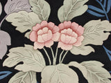 Detailed blush floral blossoms and silver-green leaves with carved pile on a modern vintage rug.