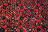 Dense pile with intricate Herati motif in cherry red and sapphire blue.